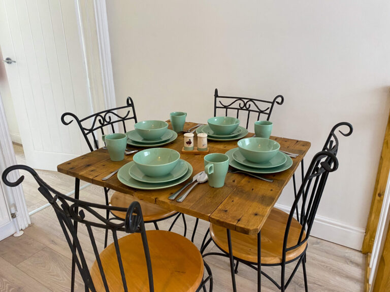 Bistro dining table with wrought-iron chairs in the 2-Bed Apartment