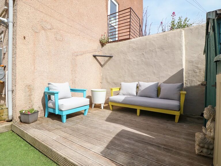 Private enclosed back garden with decking at the Clifton Road holiday home