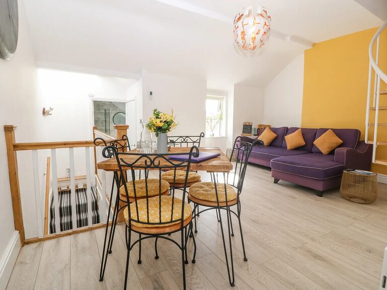 2-Bed Apartment open-plan living room with mustard feature wall